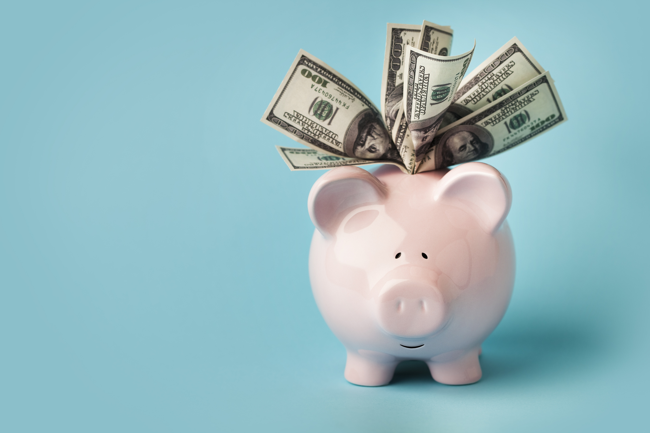 Piggy bank with dollar bills - dental treatment financing